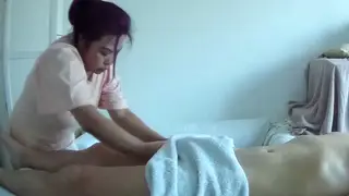 Asian Masseuse Delivers Oiled Handjob and Cumshot in Parlor