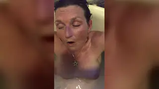 Mature Brunette Explores Intense Arousal in Bathroom Setting