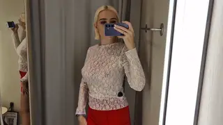 Busty Woman Models Sheer Lingerie Inside a Mall Fitting Room