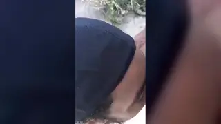 Two Men Share a Blowjob on a Sunny Beach