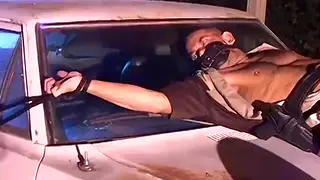 Bound Officer Struggles Against Outdoor Restraints