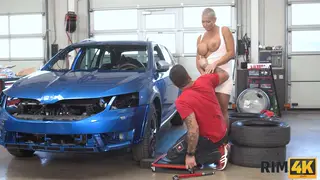 Blonde MILF Rims Mechanic Before Titjob in Garage
