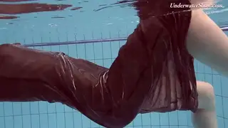 Redhead Teen Swims Nude in Outdoor Pool