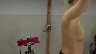 Blonde Submissive Endures Whipping Machine in Miniskirt Bondage