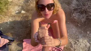 Blonde Kneels on a Mountain Ridge for a Deep Throat Finish