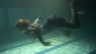 Redhead Teen Teases Underwater in a Sunlit Pool