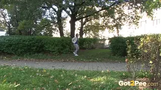 Brunette European Pisses Outdoors on Grass