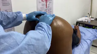 Curvy BBW in Uniform Examines a Patient at the Desk