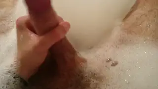 Two Guys Share Intimate Handjob Play in the Bathtub
