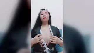 Asian Woman Enjoys Solo Play in a Bright Room
