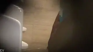 Mature Man Relieves Himself in a Public Bathroom