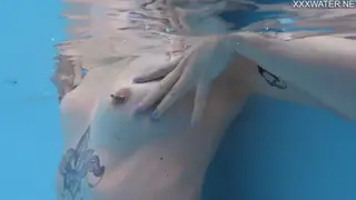 Tattooed Blonde Teen Pisses in Outdoor Pool