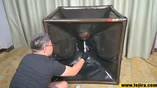 Japanese Femdom Teases Bound Sub in Latex Vacuum Box
