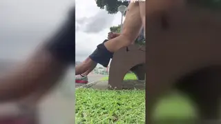 Asian Guy Enjoys Solo Moment in the Park