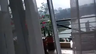 Vietnamese Brunette Enjoys the View on Her Balcony