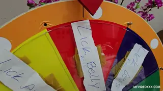 Brunette Latina Spins a Wheel for Playful Fun
