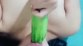 Asian Woman Pleasures Herself With Cucumber Toy