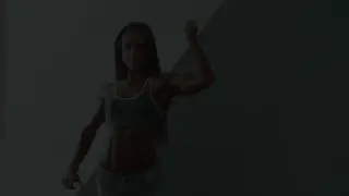 Muscular Female Bodybuilder Flexes Hard in Gym