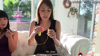 Japanese Lesbians Share Vibrators on a Plush Couch