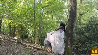 Bride in White Lace Rides a Black Stud Outdoors Before the Wedding