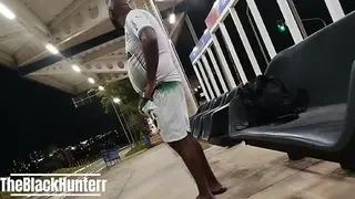 Mature Bear in Uniform Pisses Outdoors Near Vehicle