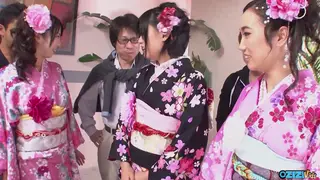 Asian Cosplayers in Kimonos Share a Passionate Group Encounter