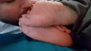 Woman Receives Foot Worship While Lying in Bed