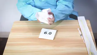 Asian Nurse in Latex Gloves Conducts Medical Exam