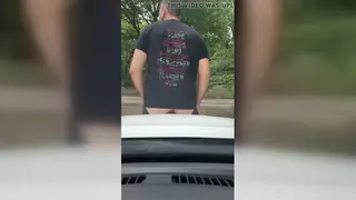 European Guy Rides Giant Toy on Car Hood Outdoors