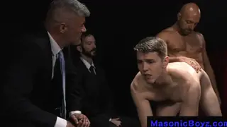 Suited Businessmen Dominate a Muscular Twink in a Dungeon Orgy