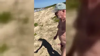 Mature Nudist Strolls Beach With Firm Erection