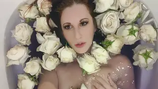 Redhead Teases Sensually in Rose-Filled Bath