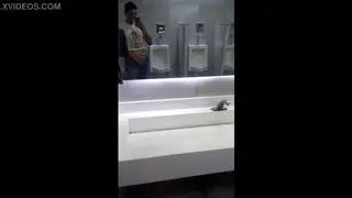 Guy Strokes to Cumshot in Public Bathroom
