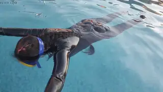 Brunette MILF Holds Breath in Latex Catsuit by the Pool