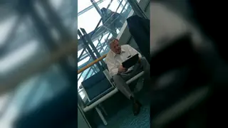 Mature Daddy Enjoys Quiet Solo Moment in Airport