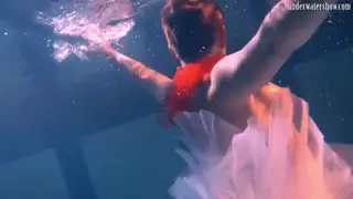 Redhead Teen Teases in a Skirt Beneath the Waves
