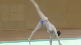 Flexible Brunette Stretches for Her Coach on the Mat