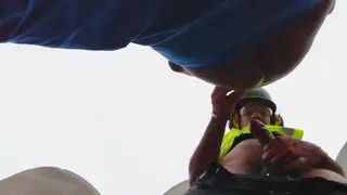 Two Workers Sneak a Quick Kiss on a Construction Site