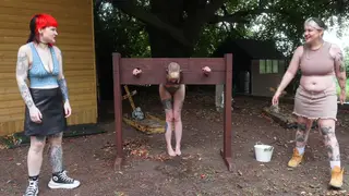Mature Femdom Trio Degrades Submissive Outdoors with Pissing