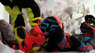 Motocross Rider in Leathers Gets Serviced on the Track