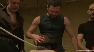 Bound Stud Endures a Public Gangbang While Suspended Upside Down