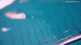 Brunette Teen Poses Underwater in a Pool