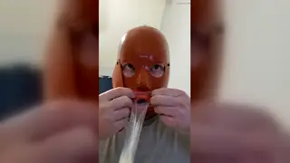 Bound Femboy in Latex Hood Deepthroats and Swallows