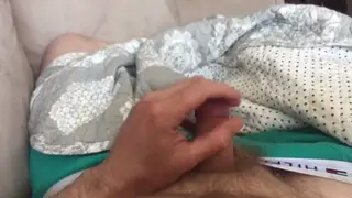 Muscular Guy Strokes His Uncut Cock on the Couch