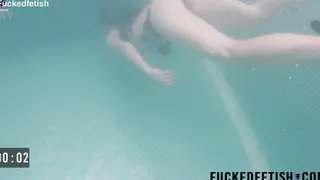 Petite Beauty Glides Underwater in Sheer Lingerie