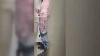 Inked Guy Strokes His Big Cock in a Public Bathroom Stall