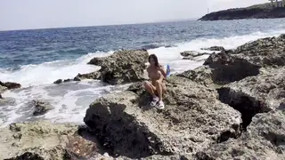 Busty Brunette Milf Fucks Octopus Toy on Public Beach