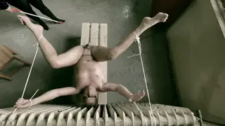 Voluptuous Domina Spanks Her Prisoner in a Cell