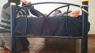 Bound Man Restrained on Bed in Bondage Scene