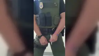 Uniformed Officer Marks His Desk with a Hot Stream